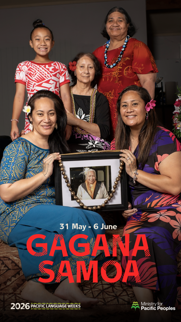 A photo of a family group of Samoan women in cultural attire, surrounding a portrait of one of their ancestors